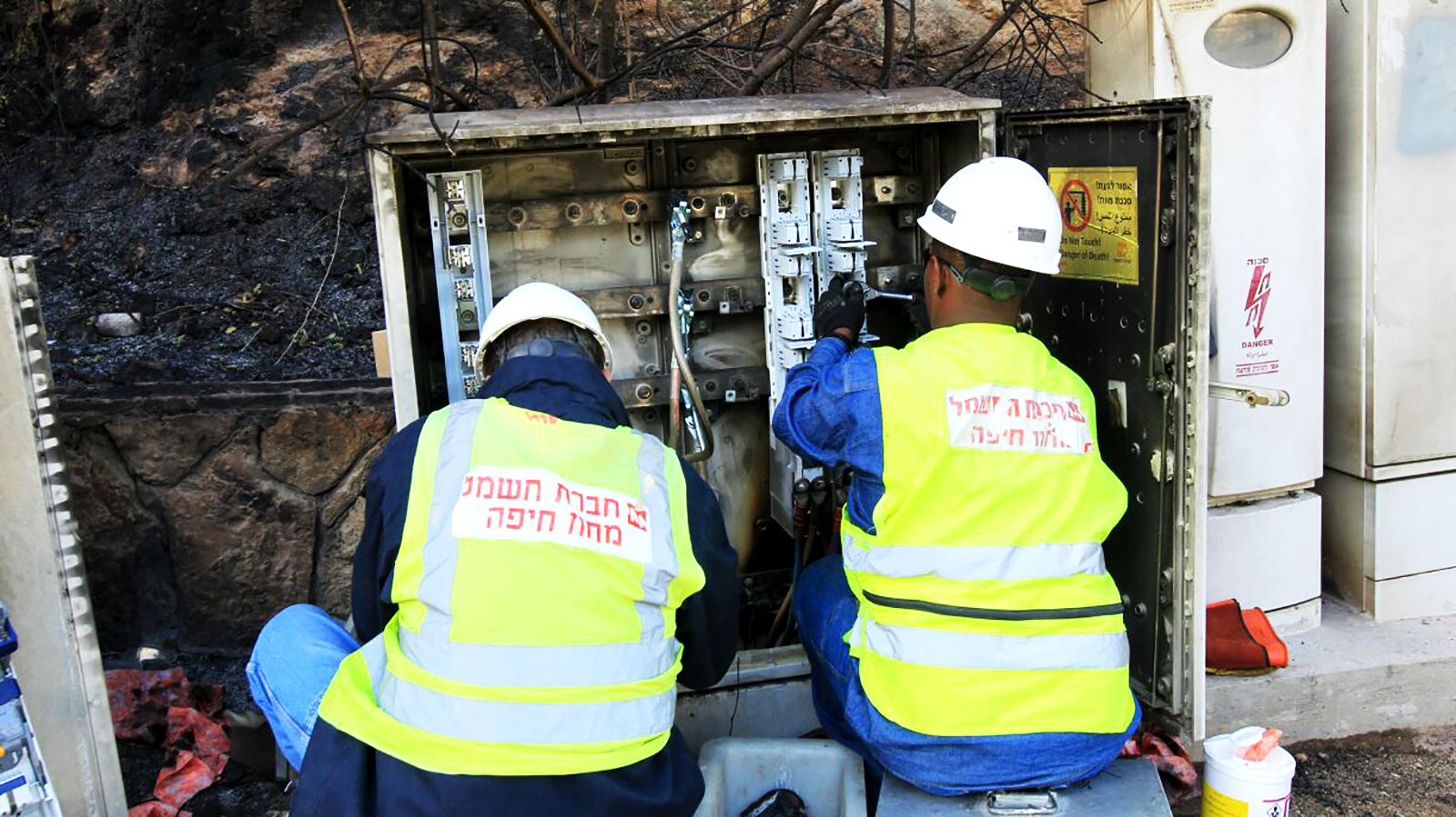 עובדי חברת החשמל בתיקון נזקי השריפה ברחוב האורן בחיפה (קרדיט: יוסי וייס, חברת החשמל).