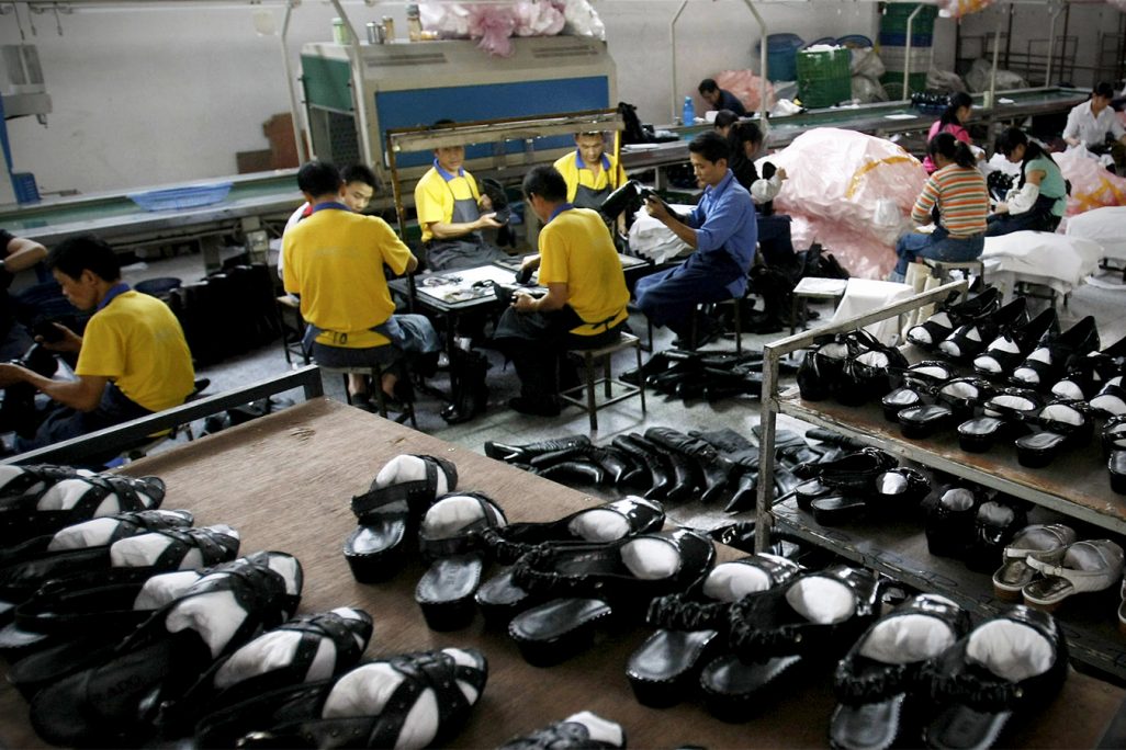 פועלים במפעל נעליים בסין (צילום: סוכנות AP).