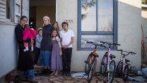 משפחת בוארון בפתח ביתה בעמונה (צילום הדס פרוש / פלאש 90).