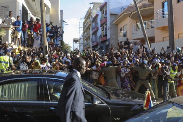 נשיא גמביה אדאמה ברו הנבחר (במרכז) מובל למכוניתו לאחר שהושבע בשגרירות בסנגל (צילום: AP)