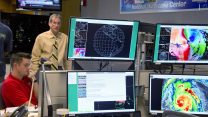 Hurricane Specialist Robbie Berg, left, and Ed Rappaport, right, the acting director of the National Hurricane Center, participate in a coordinating conference call for a Hurricane Irma forecast package Saturday, Sept. 9, 2017, at the hurricane center in Miami. (AP Photo/Andy Newman)