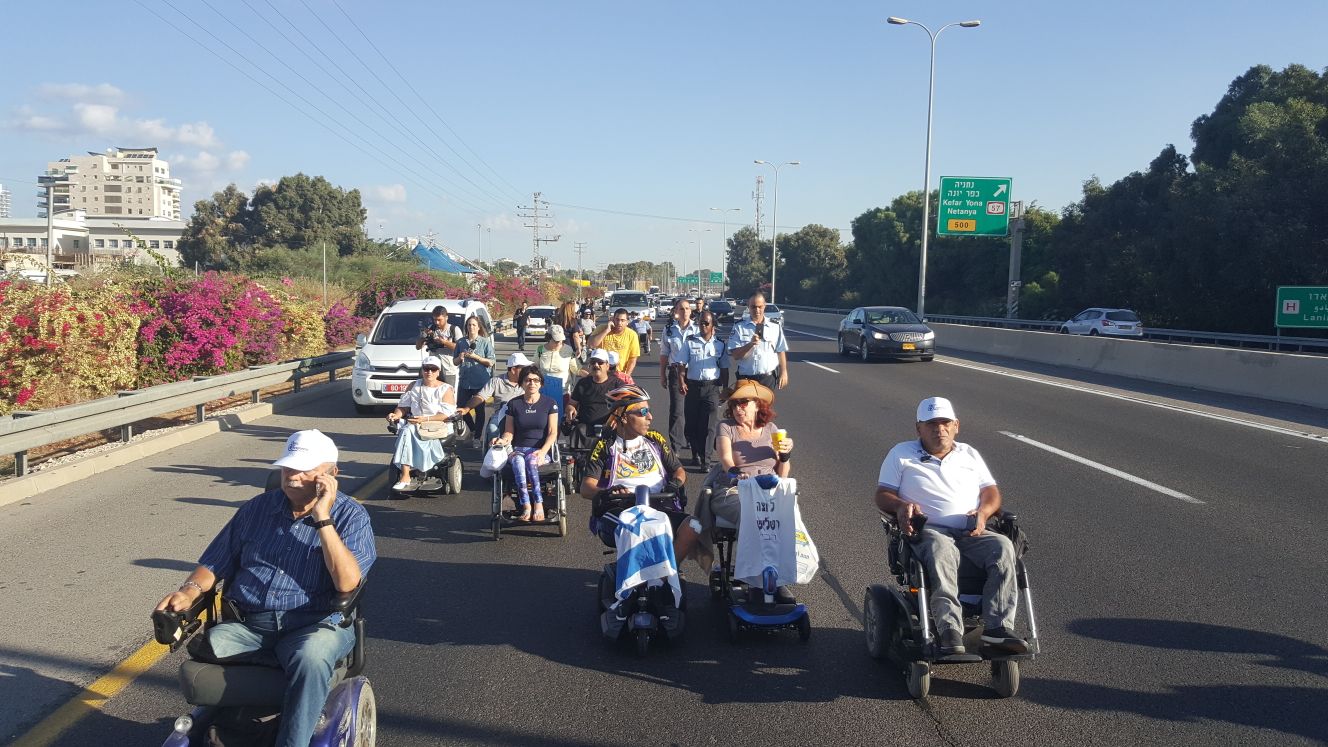 Blocking a lane of traffic on Highway No. 2 near Netanya as part of the disability rights struggle, Oct. 2018 (Photograph: Disabled Become Panthers group)