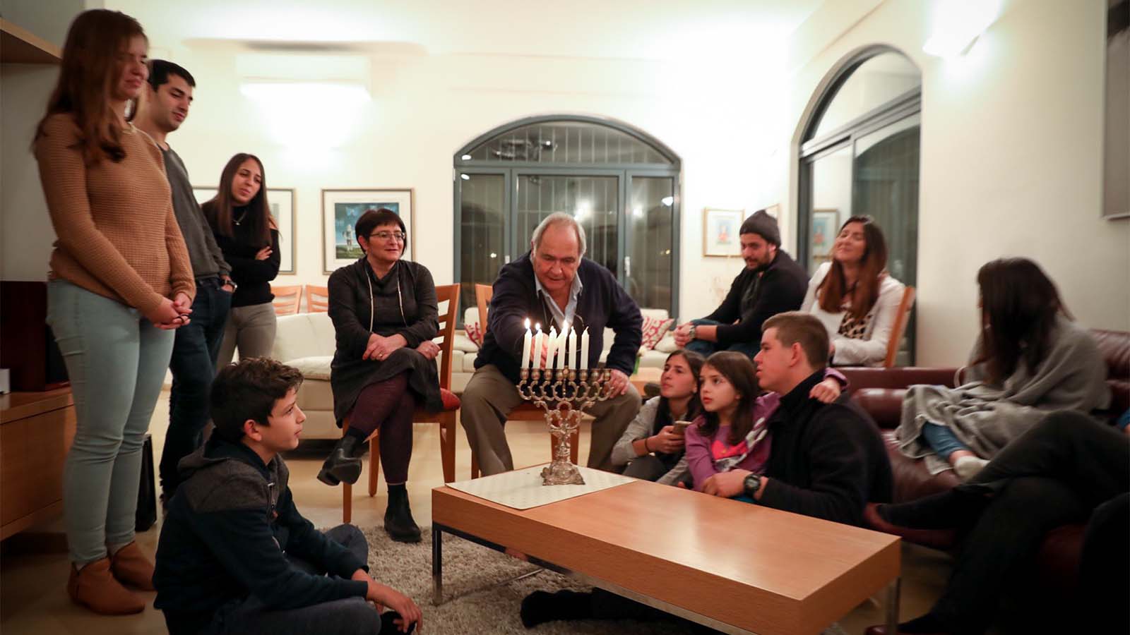 A family lights Hannukah candles, 2016 (Photograph: Nati Shohet / Flash90)