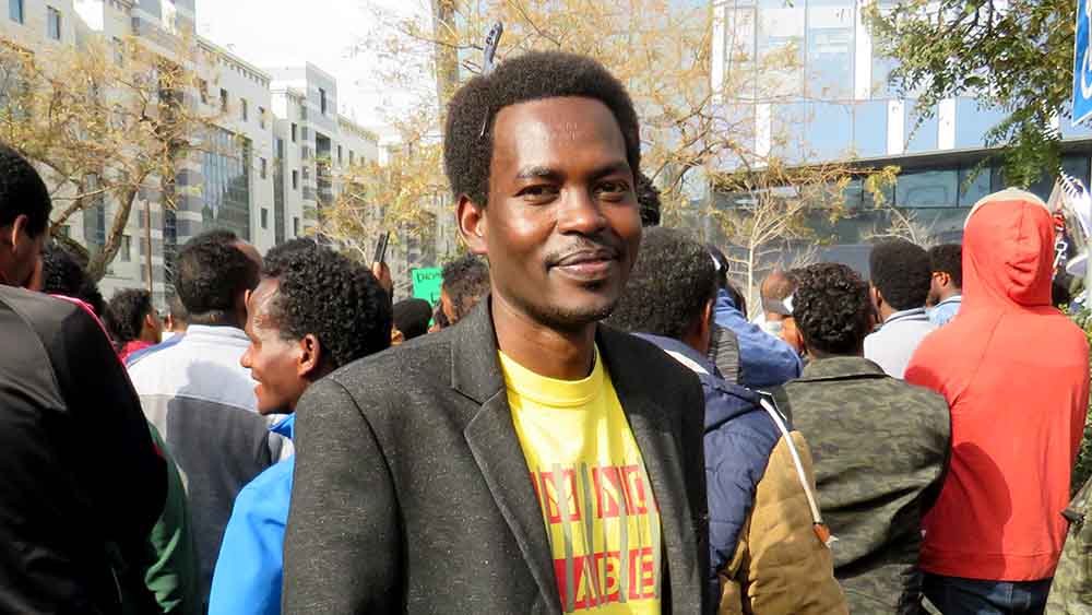 עלי יו&quot;ר ארגון המרכז לקידום פלטים אפריקאים בהפגנה מול שגרירות רואנדה בהרצליה, 7 בפברואר 2018 (צילום: יהל פרג')