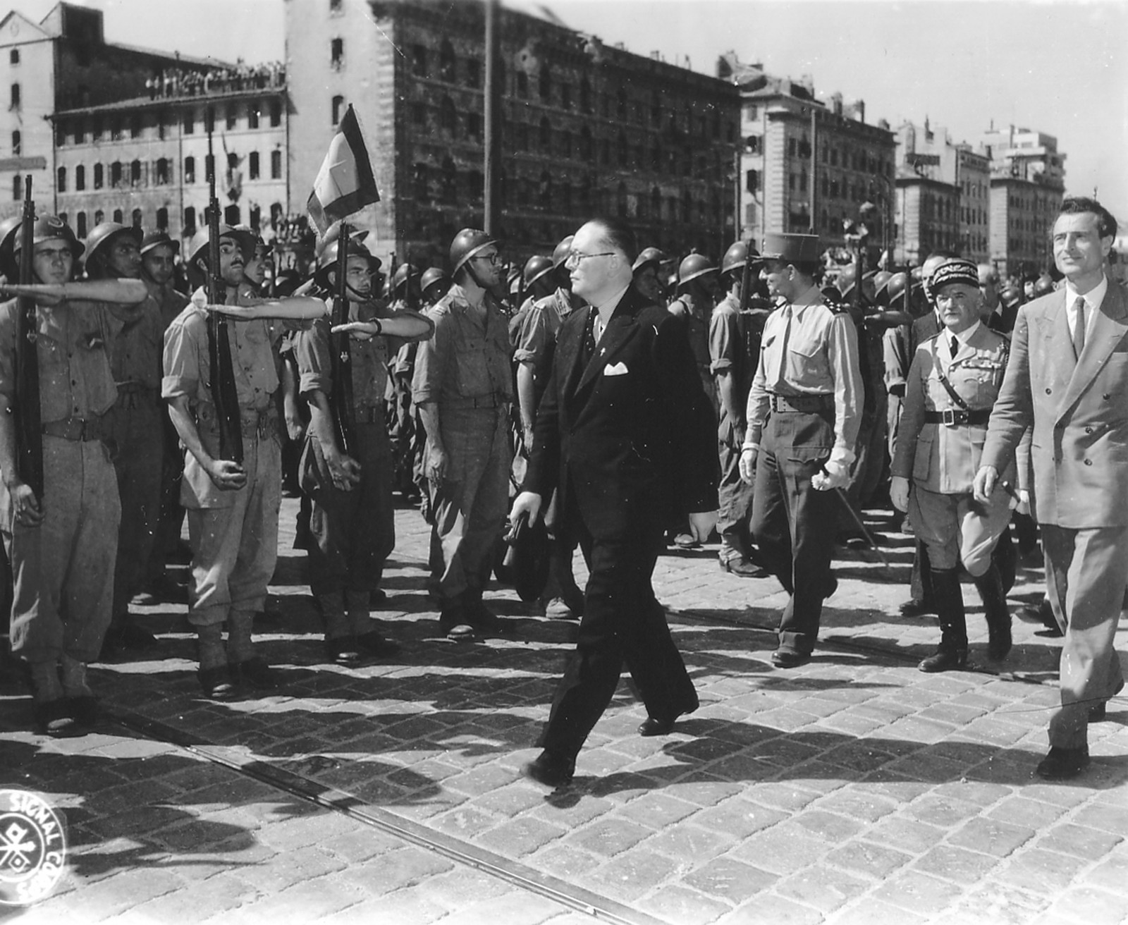 אנשי הממשלה הצרפתית הגולה צועדים במרסיי לאחר שחרורה מהנאצים, 29 אוגוסט 1944, מול משמר של אנשי רזיסטנס. עמנואל ד'סטייה, אשר כתב את המילים לשיר הפרטיזן, הוא האיש מימין בתמונה. צלם לא ידוע, מקור ויקיפדיה