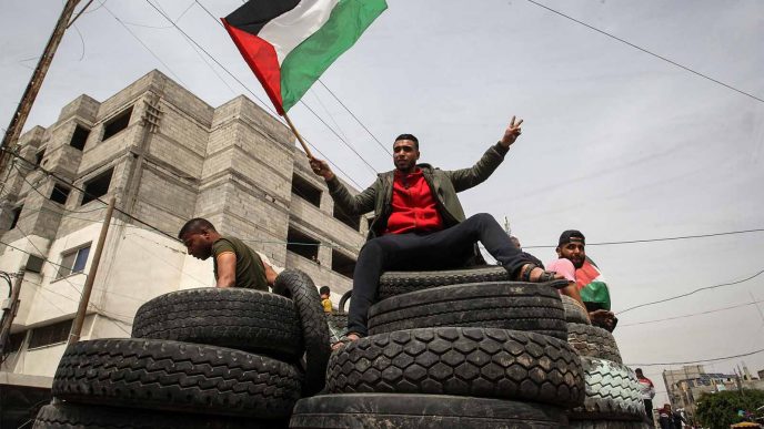 פלסטינים בעזה אוספים צמיגים לקראת ההגפנות בשישי. 5 באפריל (צילום: עבד ראחים כתיב/פלאש90)