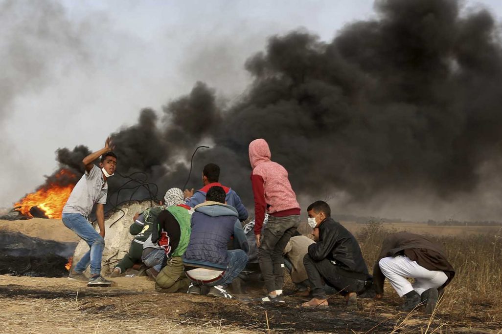 עזתים מבעירים צמיגים ומתעמתים עם כוחות צה"ל מול גדר הגבול ליד חאן יונס. 5 באפריל (AP Photo/Adel Hana)
