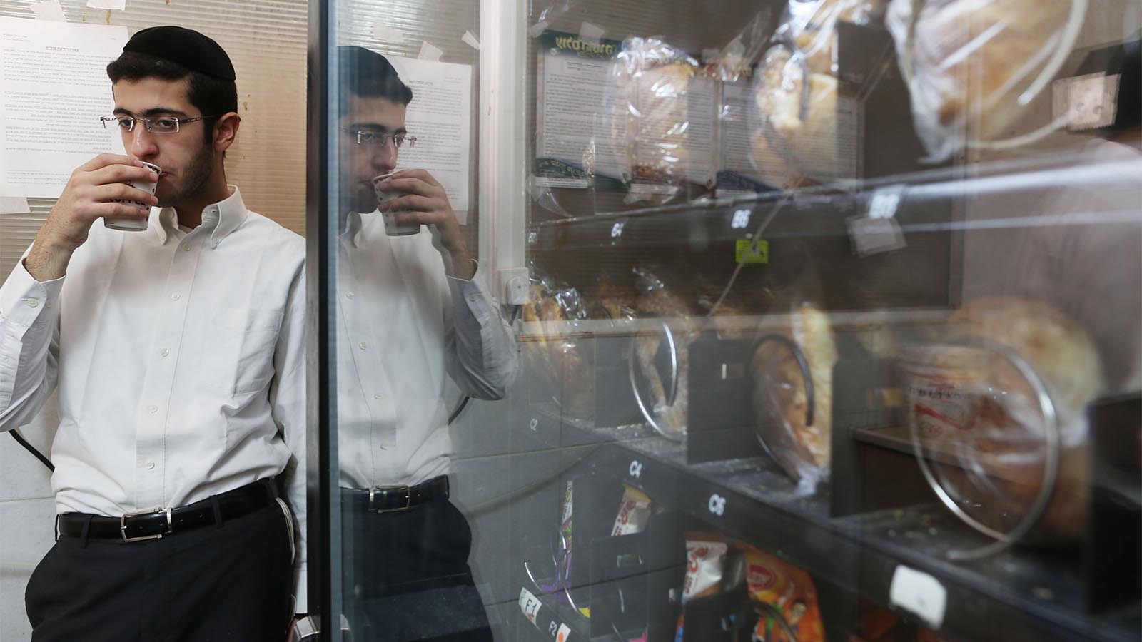 צעיר חרדי שותה ממכונת משקאות בישיבה בירושלים. למצולם אין קשר לכתבה (צילום: נתי שוחט/ פלאש90)