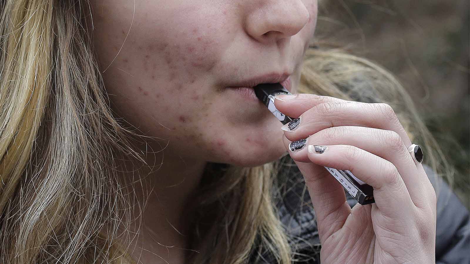 נערה מעשנת סיגריה אלקטרונית של JUUL (צילום: AP Photo/Steven Senne)