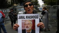 An activist, member of the Human Rights Association Istanbul branch, holds a poster with a photo of missing Saudi journalist Jamal Khashoggi, during a protest in his support near the Saudi Arabia consulate in Istanbul, Tuesday, Oct. 9, 2018. Turkey said Tuesday it will search the Saudi Consulate in Istanbul as part of an investigation into the disappearance of a missing Saudi contributor to The Washington Post, a week after he vanished during a visit there.   (AP Photo/Lefteris Pitarakis)