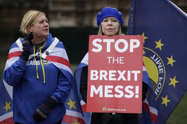 Anti-Brexit remain in the European Union supporters hold placards as they demonstrate opposite the Houses of Parliament in London, Monday, Jan. 21, 2019. Prime Minister Theresa May on Monday rejected calls to delay Britain’s departure from the European Union. (AP Photo/Matt Dunham)