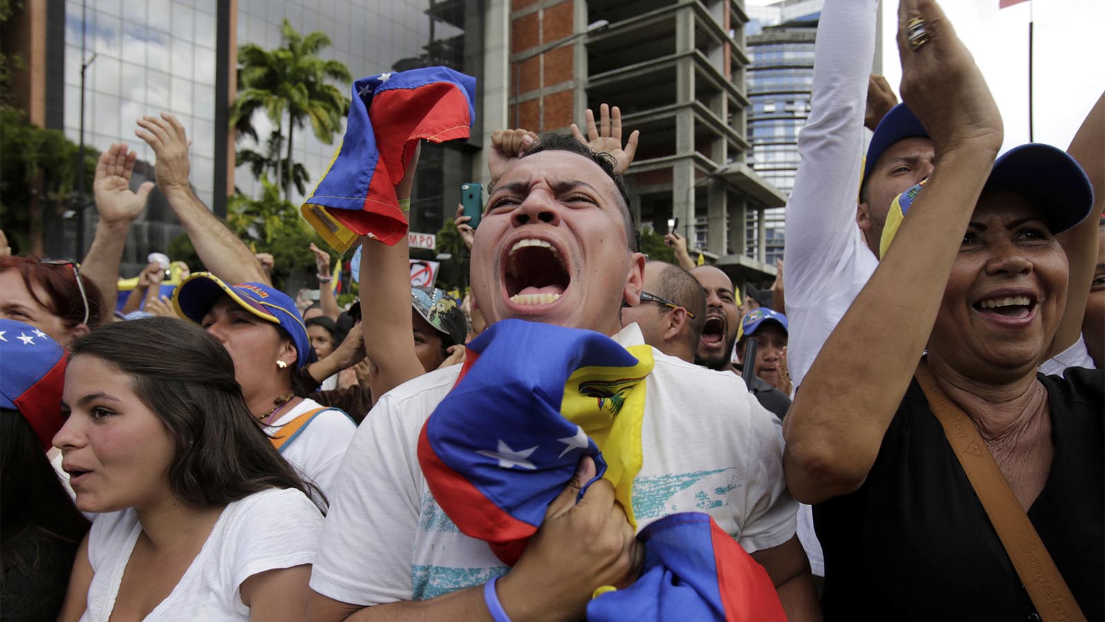 Anti-government protesters cheer as Juan Guaido, head of Venezuela's opposition-run congress, declares himself interim president of the South American country until a new election can be called, at a rally demanding the resignation of President Nicolas Maduro in Caracas, Venezuela, Wednesday, Jan. 23, 2019. (AP Photo/Boris Vergara)