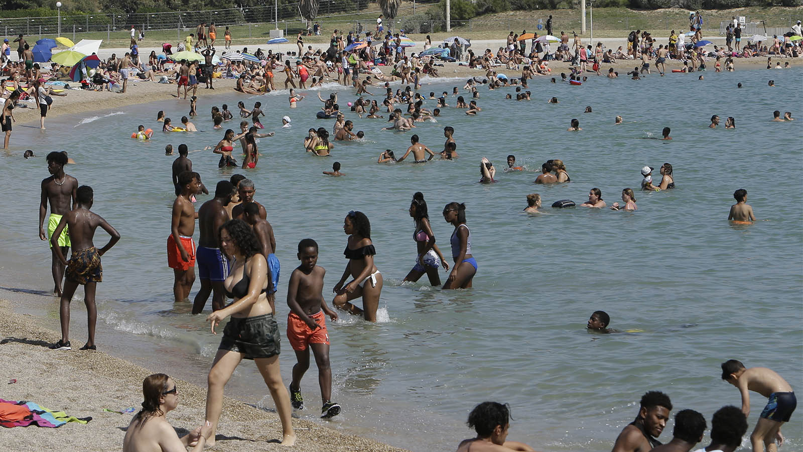 רוחצים בחוף הים במרסיי במהלך גל החום הקיצוני באירופה, יוני 2019 (AP Photo/Claude Paris)