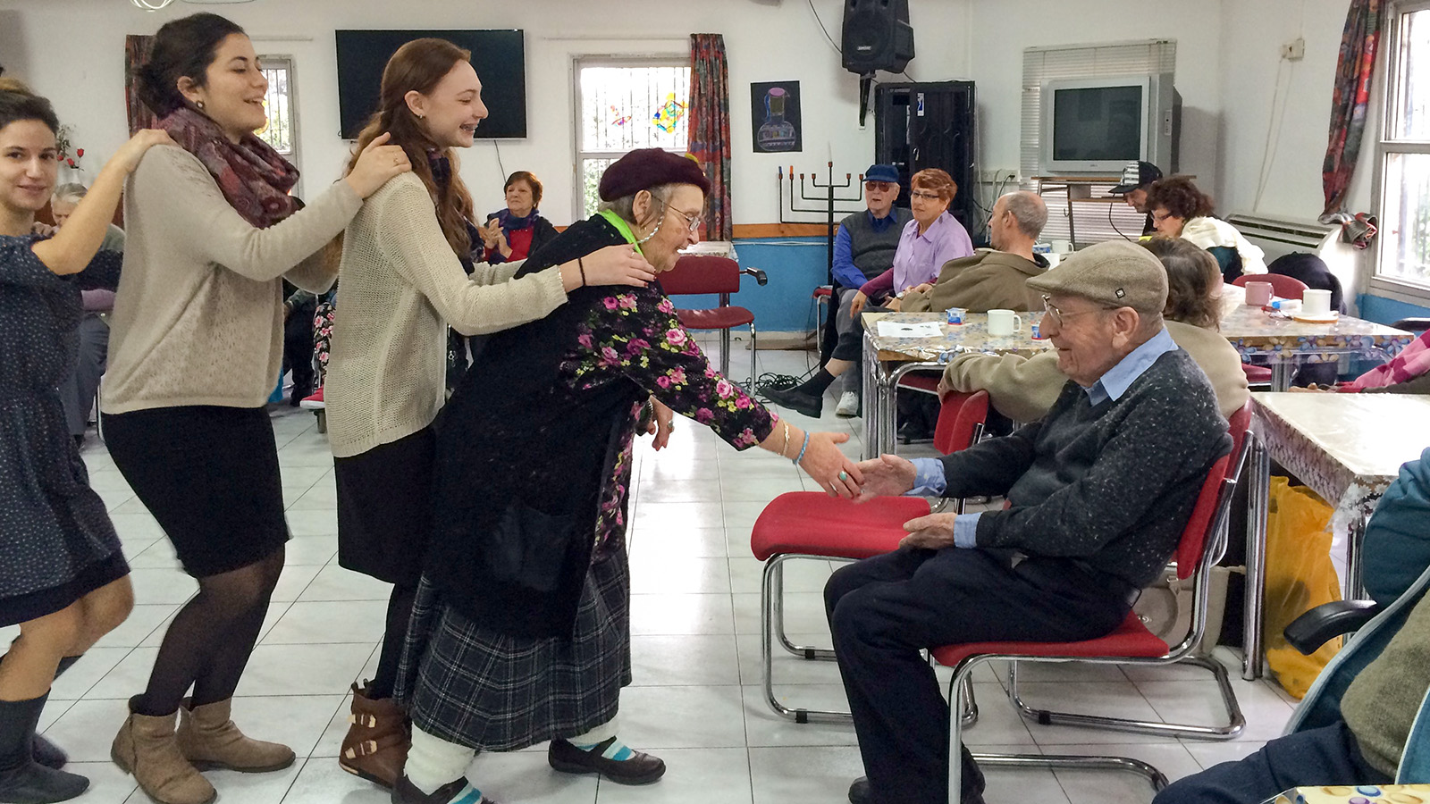 Teenagers volunteering at a retirement home (Photograph: Michal Pu)
