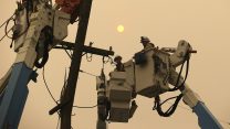 צוותי חברת החשמל הפרטית PG&E מתקנים קווי חשמל לאחר השריפה שכילתה את העיר פרדייז במדינת קליפורניה בארה"ב, 9 בנובמבר 2018. (AP Photo/Rich Pedroncelli, File)