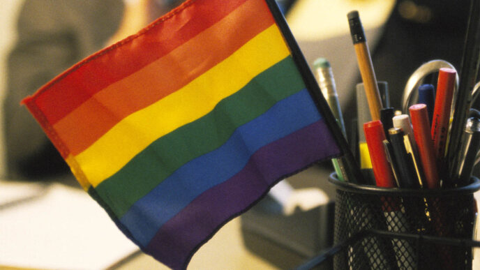 Rainbow flag in pencil holder on office desk (Ron Chapple / gettyimages)