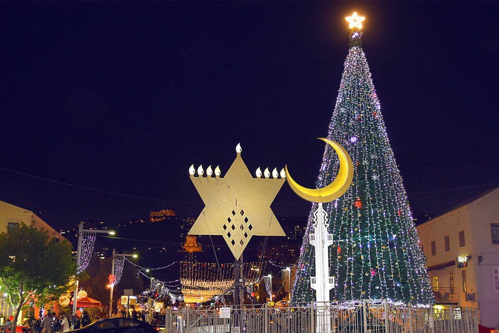 Festival of Festivals in Haifa, December 2019. From left: The Jewish star of David, Islam's Star and Crescent and a Christian Christmas tree (Photograph: irisphoto1 / Shutterstock.com)