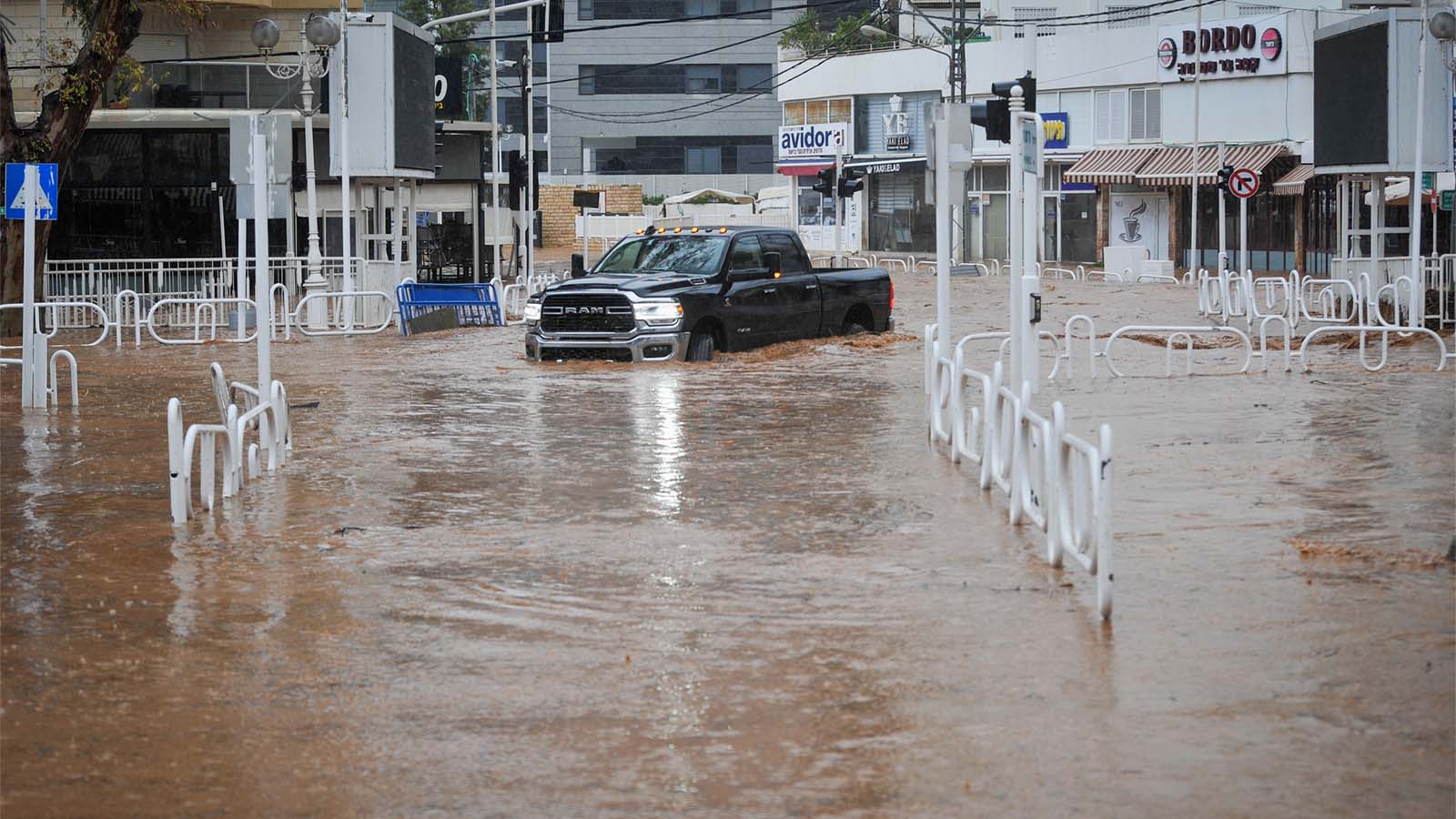 A car drives on a flooded road in the northern Israeli city of Nahariyya, on a stormy winter day, on January 8, 2020. Photograph: Meir Vaknin/Flash90