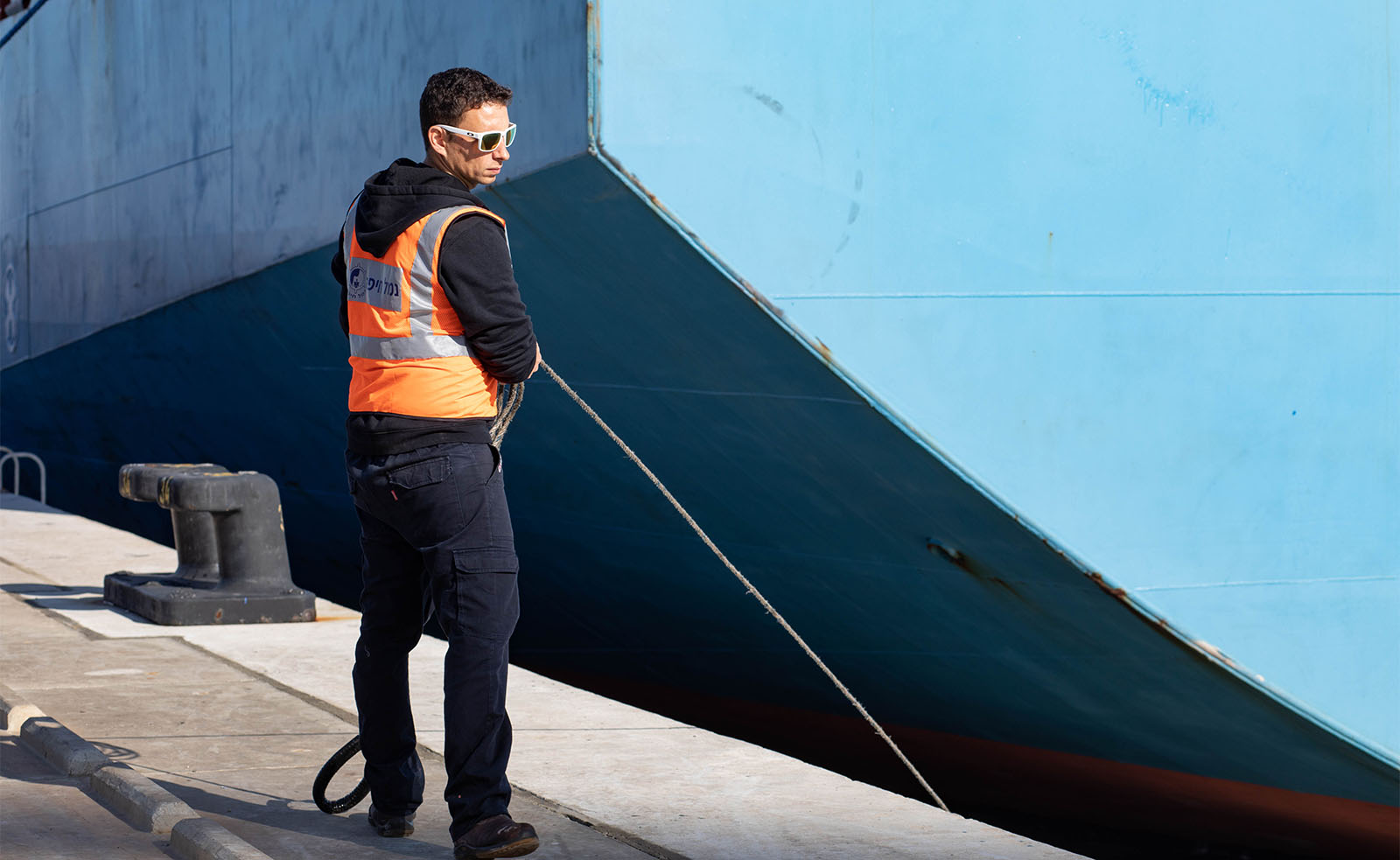 ספן בעגינה אלעד חיימוביץ קושר אוניה לרציף בנמל חיפה (צילום: גילעד שרים)