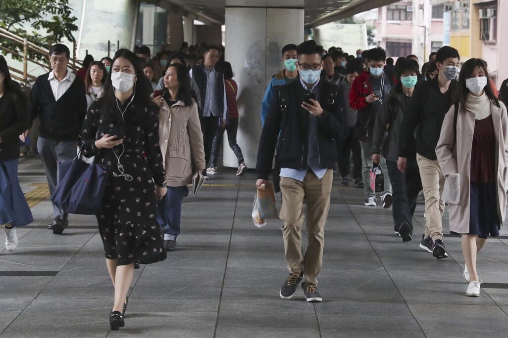 אנשים הולכים עם מסכות ברחוב בהונג קונג, 24 בינואר 2020 (AP Photo/Achmad Ibrahim)