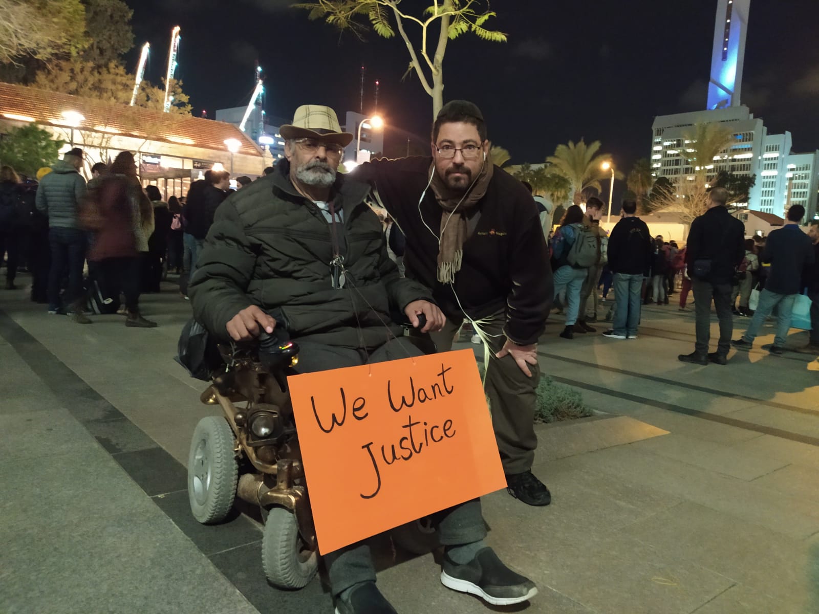 Demonstrators with a sign at the disability benefits protest in Tel Aviv, Jan. 30, 2020. Photograph: Nizzan Zvi Cohen