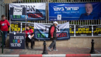 שלטי מפלגות בכניסה לקלפי בבחירות לכנסת ה-23 (צילום: מרים אלטשר/פלאש90)