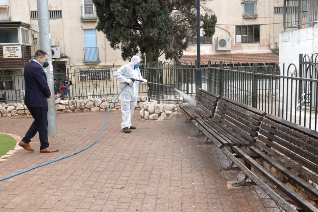 A Safed city worker disinfects public monuments around the city (photo: City of Safed)