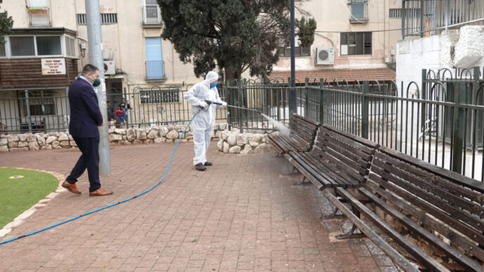 A Safed city worker disinfects public monuments around the city (photo: City of Safed)