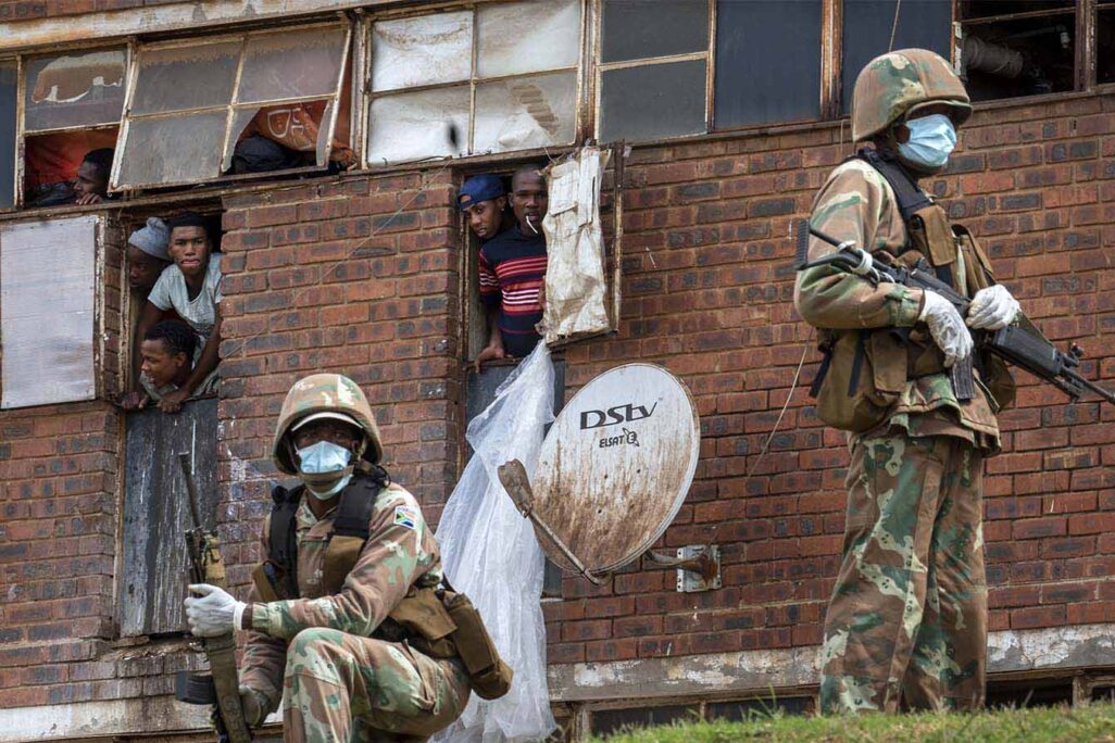 חיילי צבא דרום אפריקה שומרים על בניין מגורים ואוכפים את הסגר באלקסנדרה, דרום אפריקה (צילום: AP Photo/Jerome Delay).