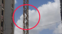 פועלים סינים מתברצים על מנוף מאתר בניה ברחובות  (קרדיט: רחובות ניוז)