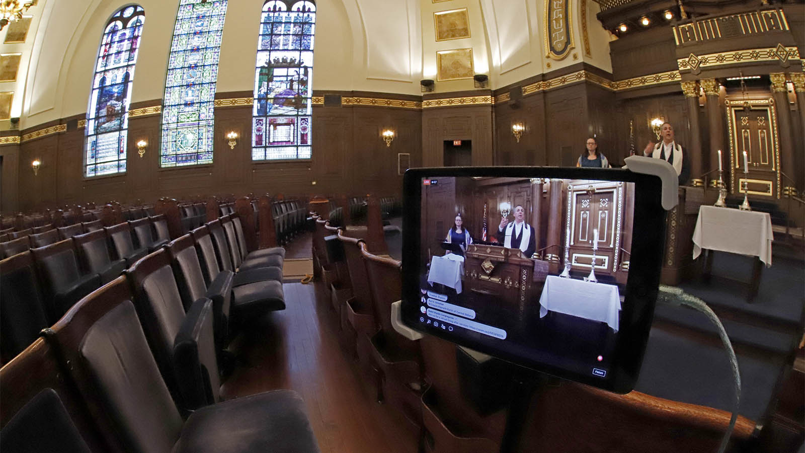 Rodef Shalom Rabbi Aaron Bisno, right, delivers his sermon during an Erev Shabbat service that is being streamed live on Facebook, Friday, March 20, 2020. (AP Photo/Gene J. Puskar)