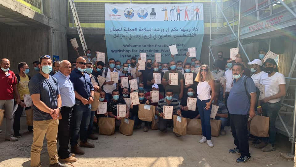 העובדים מציגים את תעודת הסיום של ההכשרה. הכשרת בטיחות לעובדים פלסטינים בבית צפאפא (צילום: אביטל שפירא)