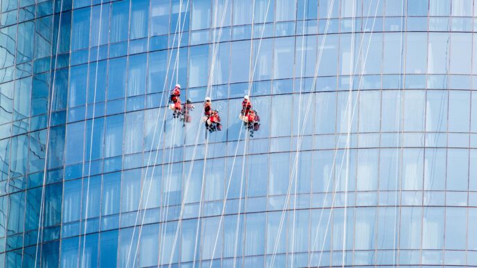Migrant workers clean skyscraper windows in Abu Dhabi. (Photo: Shutterstock)