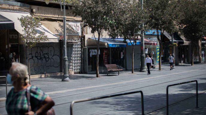 People walking by closed shops on Jaffa Street in downtown Jerusalem on September 21, 2020, during a nationwide lockdown. (Photo: Yonatan Sindel/Flash90)