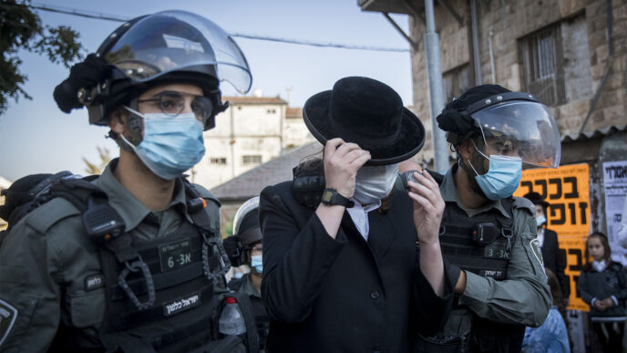 Policemen detaining an ultra-Orthodox protesting in Jerusalem, October 4 (Photo: Yonatan Zindel/Flash90)