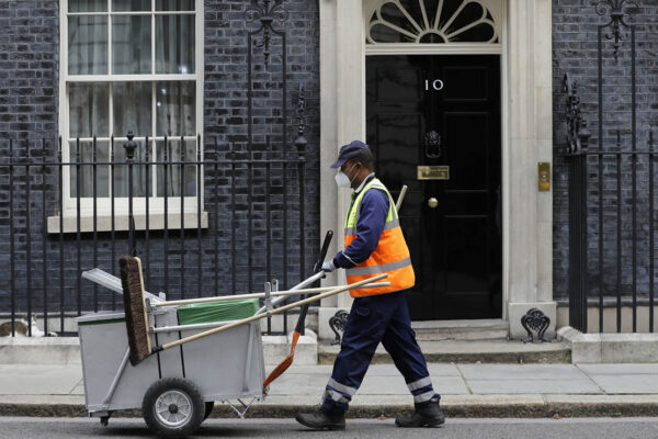 מנקה רחובות ברחוב דאונינג לונדון. "המגפה העולמית חשפה אילו עובדים הם באמת חיוניים" (צילום: AP Photo/Kirsty Wigglesworth)