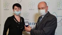 מנהל המרכז הרפואי לגליל בנהריה, פרופ' מסעד ברהום מעניק את האות למנהלת מחלקת השיקום ורופאה בכירה במחלקת הקורונה כתר מונשמים, ד"ר יוליה קובלנקו (צילום: אלי כהן)