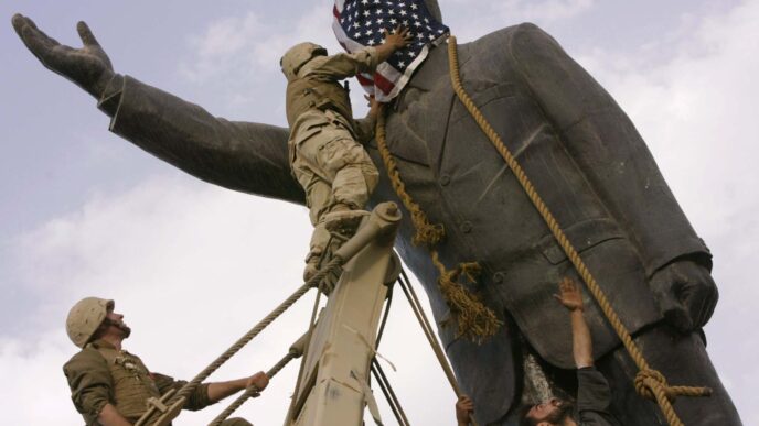 Iraqi civilians and American soldiers tear down a statue of Saddam Hussein in central Baghdad, 2003 (Photo: (AP Photo / Jerome Delay, File)
