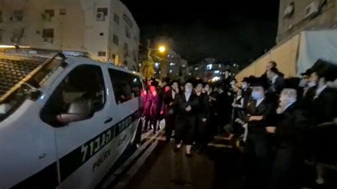 A wedding being dispersed by police in Bnei Brak. (Screenshot)