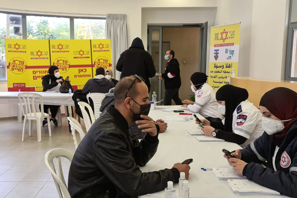 Palestinian workers receive vaccines at a vaccination center. (Photo: Magen David Adom)