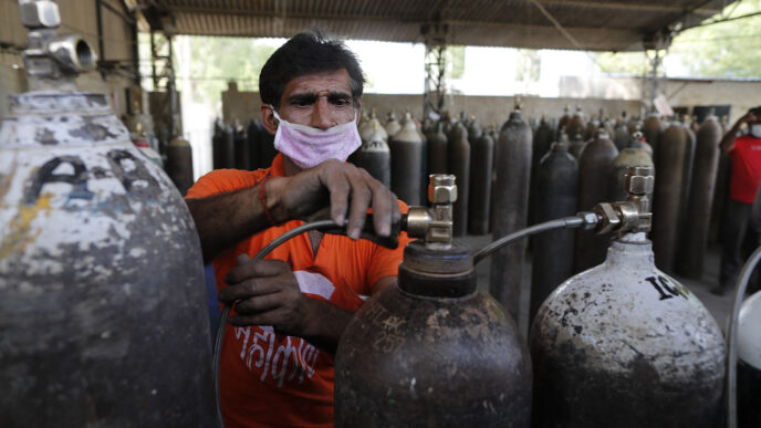 תחנה למילוי מחדש של מכלי חמצן רפואי. בשנה שעברה הוסבו לשימוש רפואי מכלים שיועדו לתעשייה (AP Photo/Rajesh Kumar Singh)