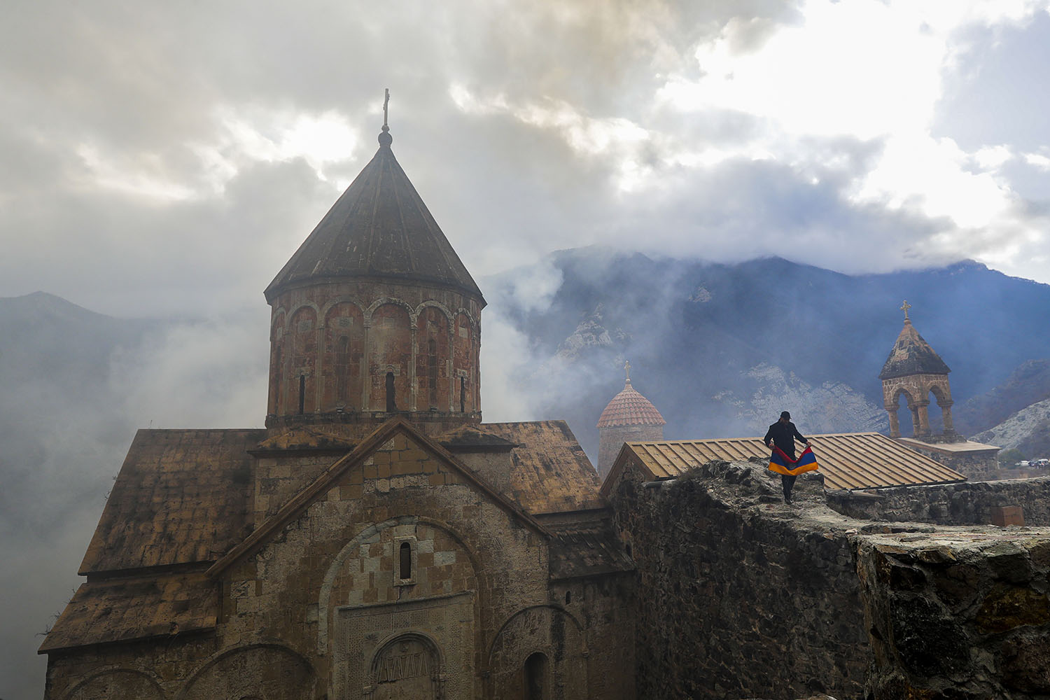 אדם מחזיק את הדגל הלאומי של ארמניה על גג מנזר דדיבאנק, בחלק של נגורנו-קרבאך שהועבר לשליטת אזרבייג'אן בהסכם לסיום המלחמה האחרונה. התרשמתי בביקורי כי הדגל שלהם ימשיך להתנוסס מעל "הגן השחור ההררי" (AP Photo/Sergei Grits)