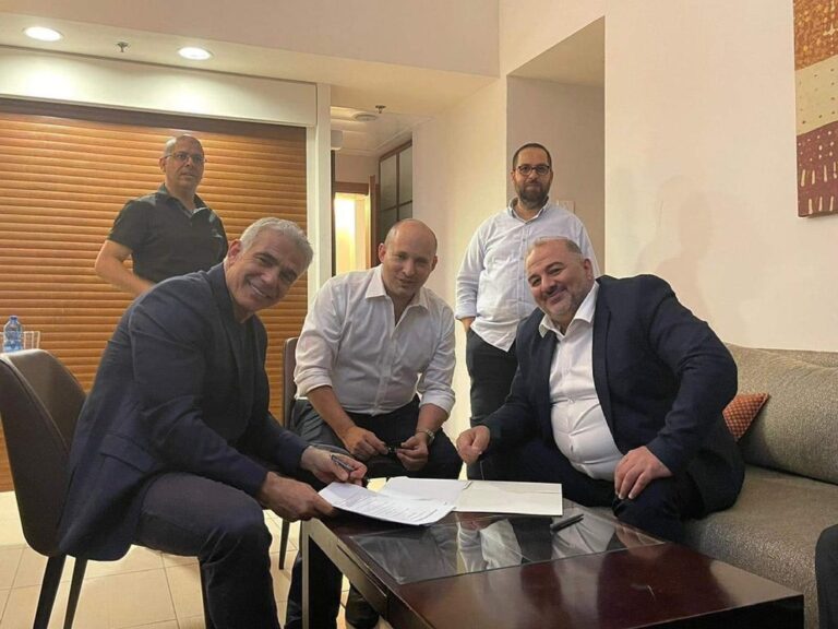Mansour Abbas, Naftali Bennett and Yair Lapid sign the coalition agreement. (Photo: Nawaf Navari)