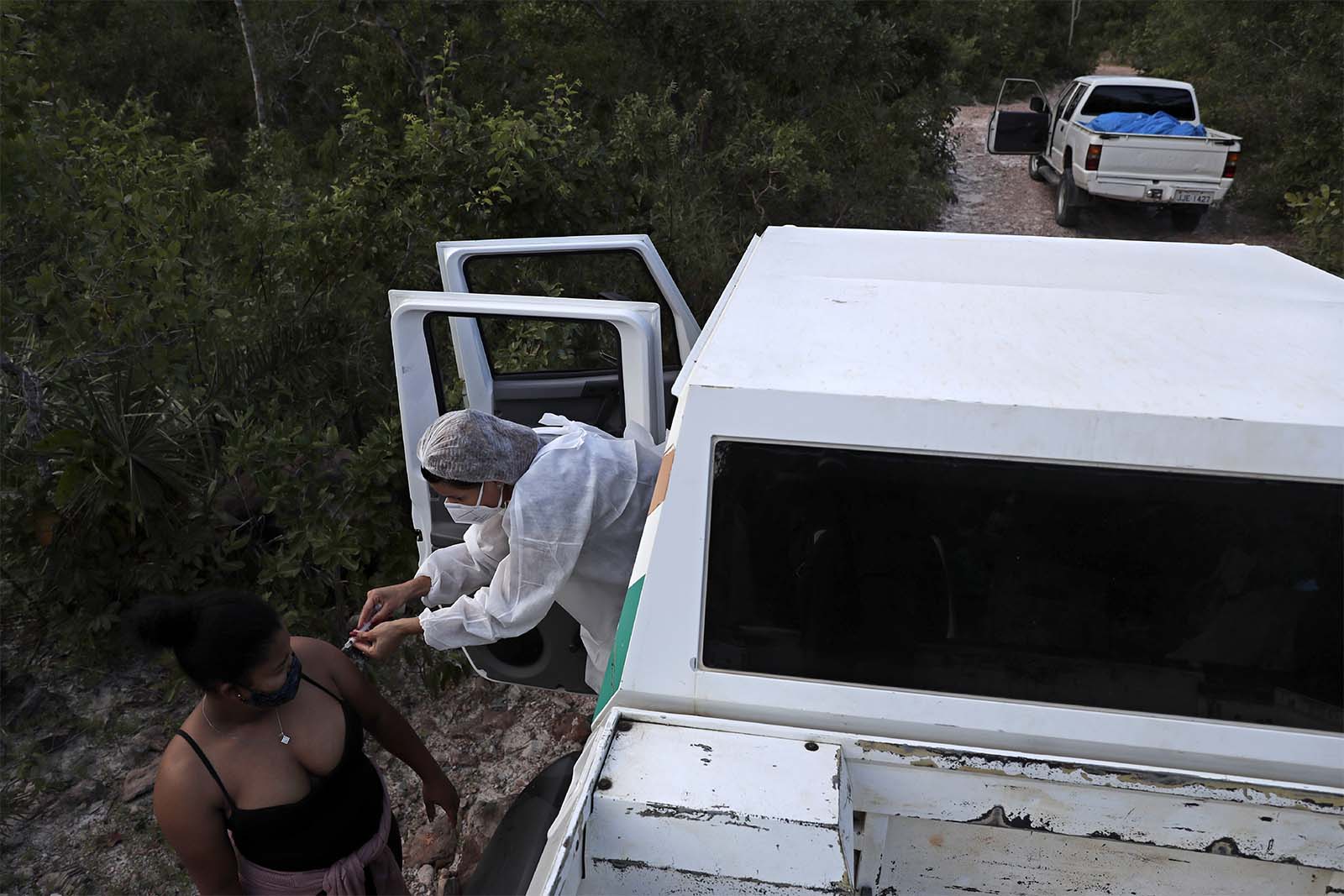עובדת בריאות מחסנת מטופלת ברכבה בשבט קלונגה וואו דה אלמאס באזור כפרי בברזיל. (צילום: AP/Eraldo Peres)