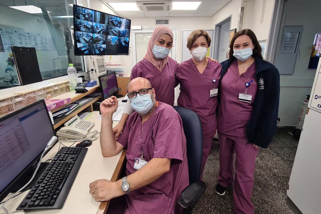 Nurses Simona Hamishkin, Irina Siderovski, Bara Khalila, and Marwan Arshid pose in Corona Ward B of the Galilee Medical Center. (Photo: Dafna Eisbruch)