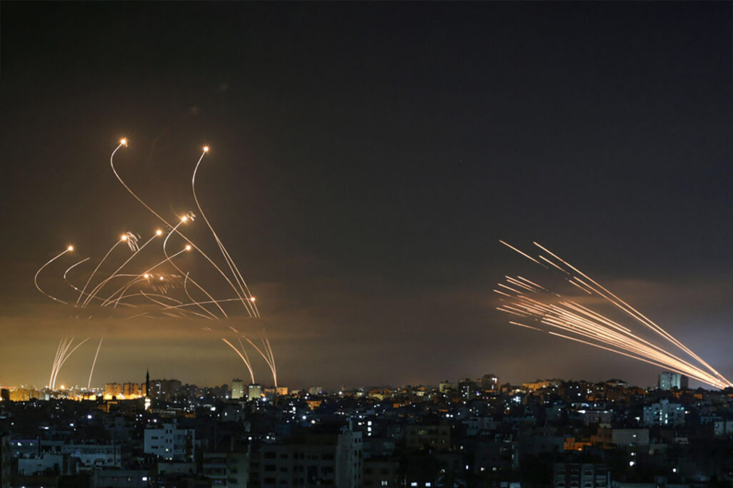 Israeli Iron Dome missile defense system (left) intercepts rockets fired by Hamas toward southern Israel from Beit Lahia in the northern Gaza Strip. (Photo: AP Photo)