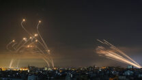 Israeli Iron Dome missile defense system (left) intercepts rockets fired by Hamas toward southern Israel from Beit Lahia in the northern Gaza Strip. (Photo: AP Photo)