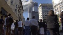 Pedestrians in lower Manhattan watch smoke billow from New York's World Trade Center on Tuesday, Sept. 11, 2001. (AP Photo/Amy Sancetta)