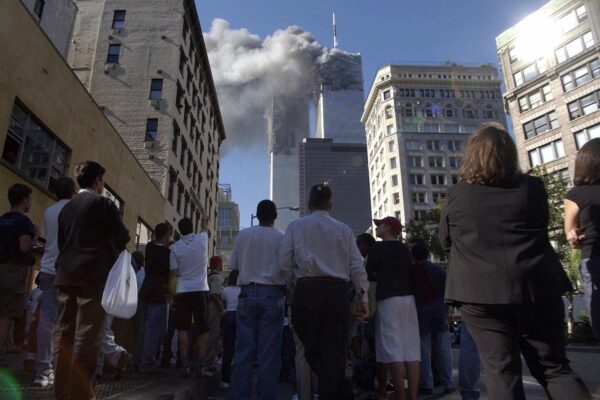 Pedestrians in lower Manhattan watch smoke billow from New York's World Trade Center on Tuesday, Sept. 11, 2001. (AP Photo/Amy Sancetta)