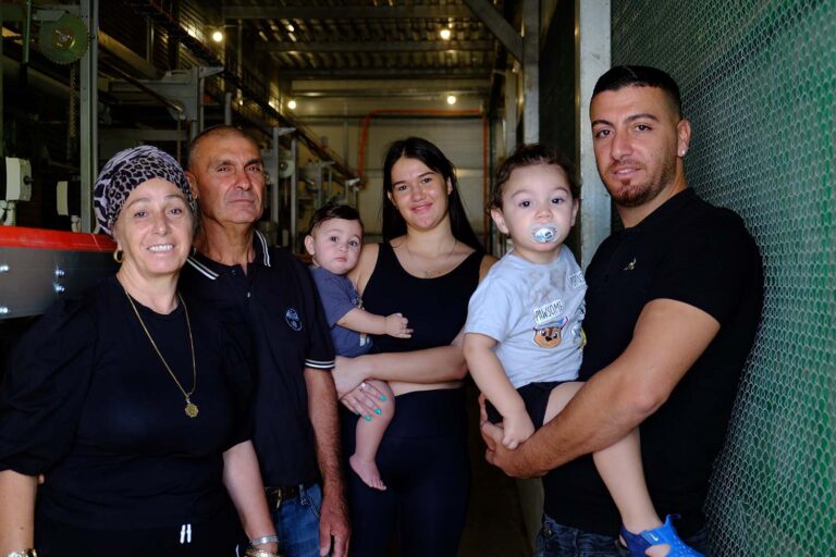 Moshe Sassi (second from right), standing with his family, struggles to turn a profit. (Photo: David Tversky)